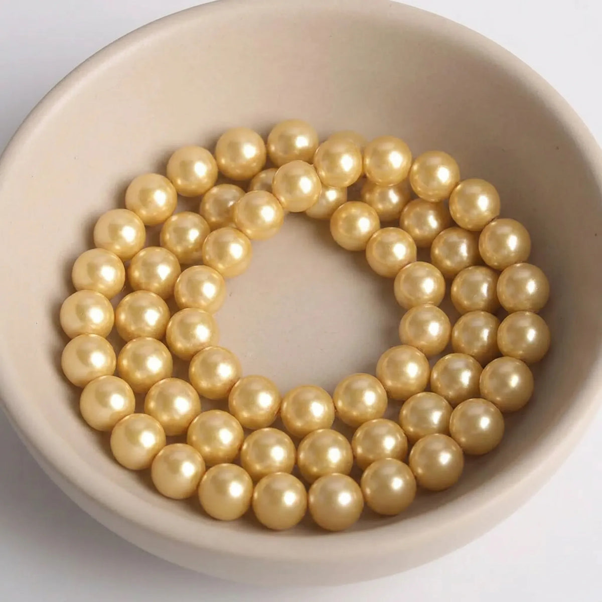 Full strand of champagne glass pearl beads with smooth pearl-coated finish