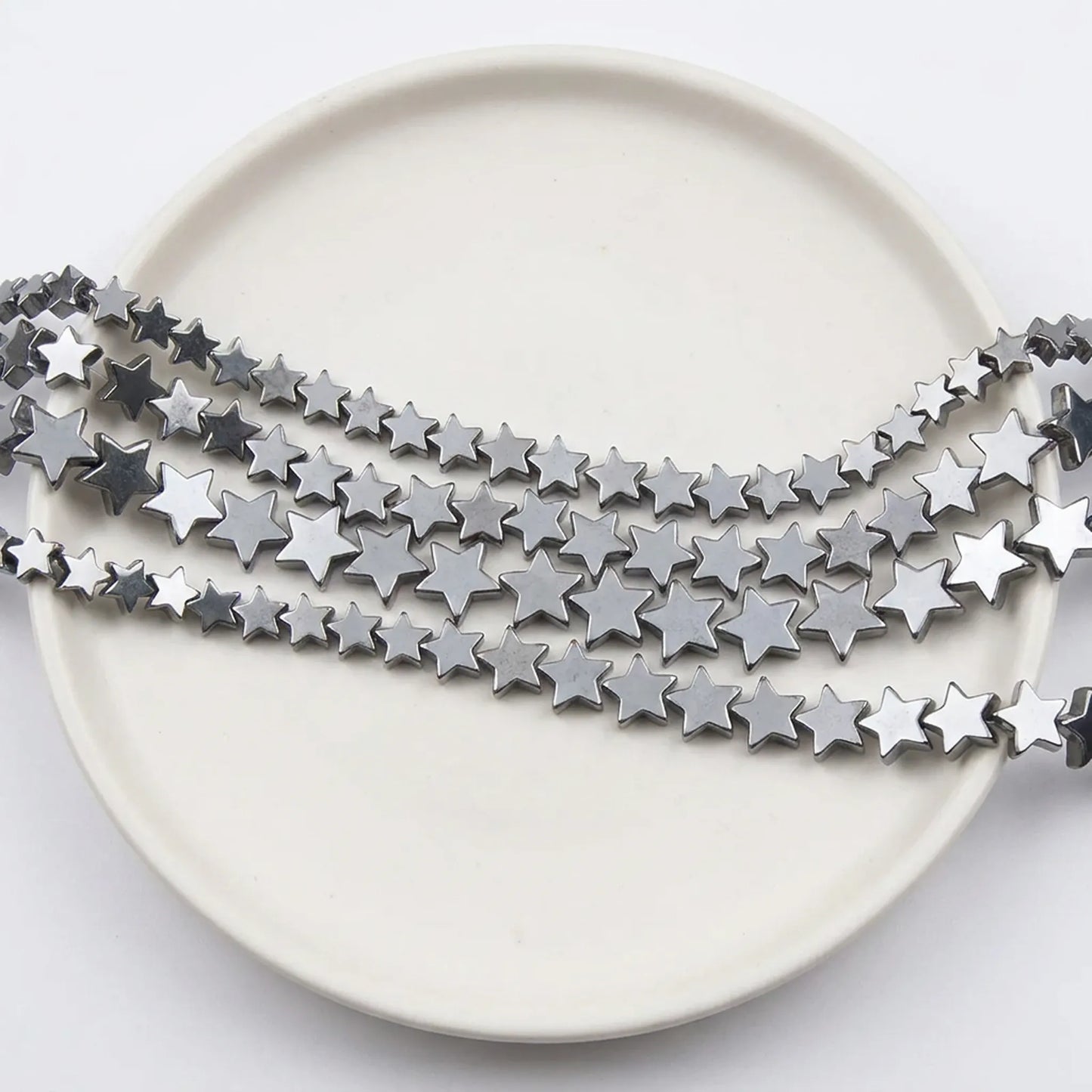 Metallic silver star hematite beads close up