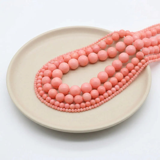 Pink coral round bead strands in assorted sizes for bracelets and necklaces