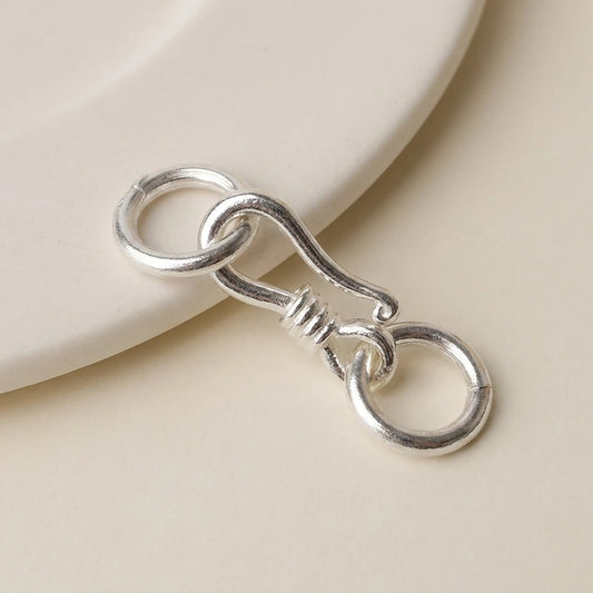 Sterling silver S hook clasp with closed jump rings close-up