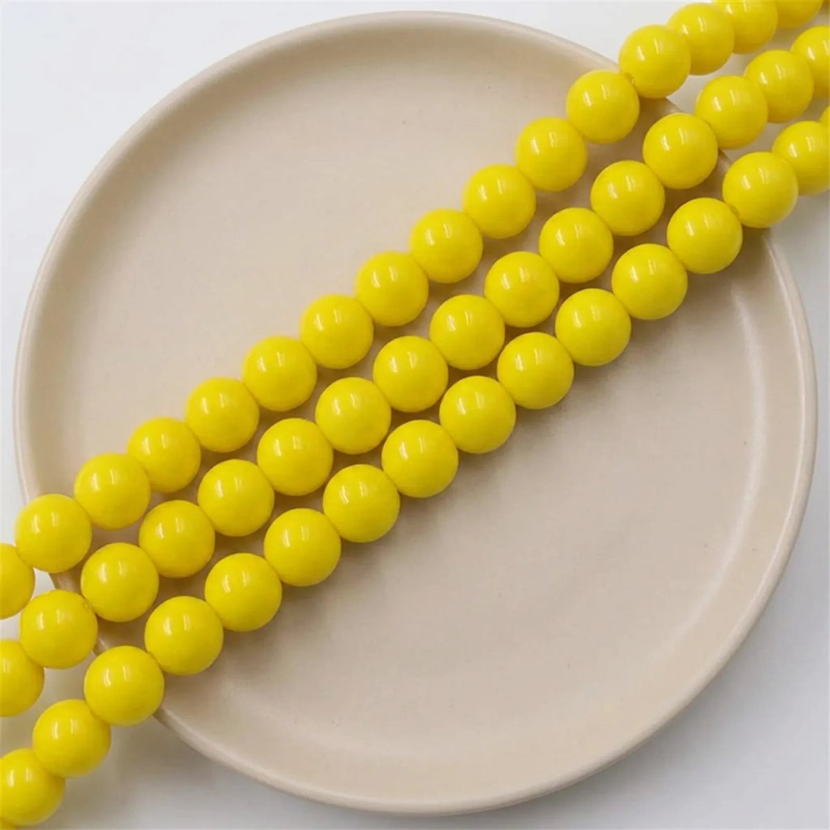Loose yellow coated opaque glass round beads
