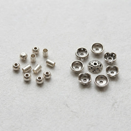 Crimp beads and decorative bead caps for jewelry making shown as separate jewelry findings