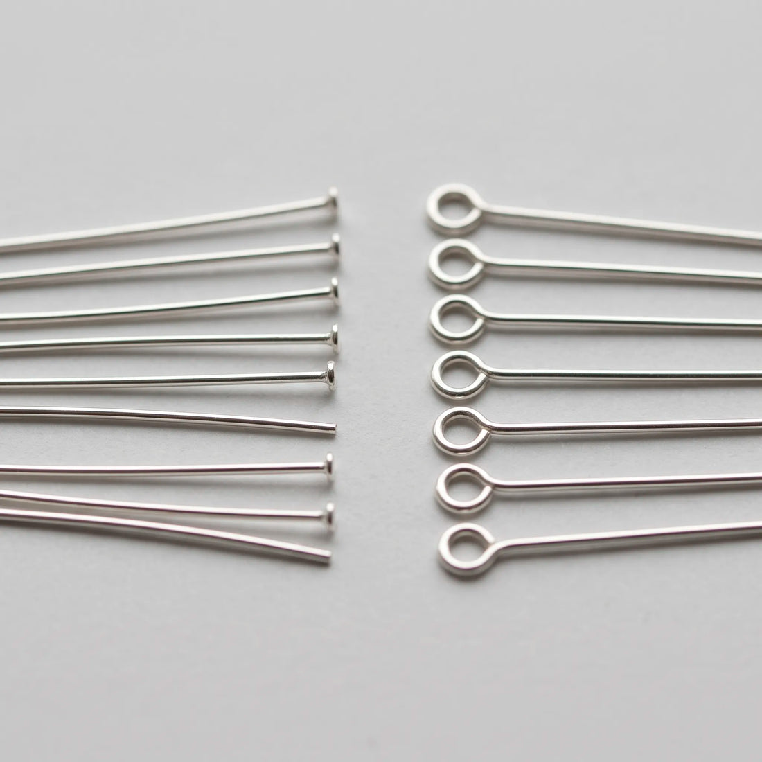 Head pins and eye pins for jewelry making shown side by side
