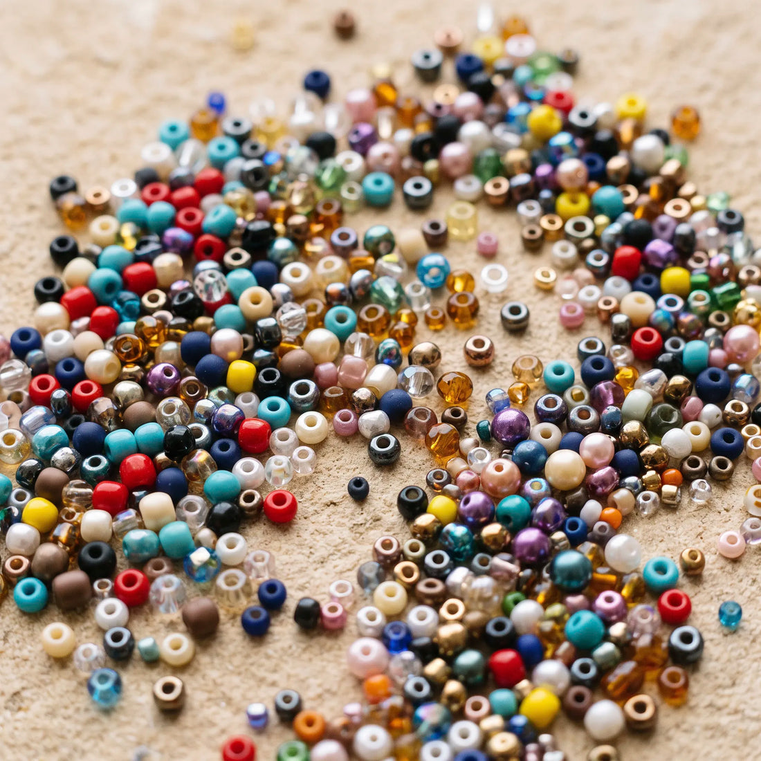 Various glass seed beads for jewelry making in different colors, sizes, and finishes