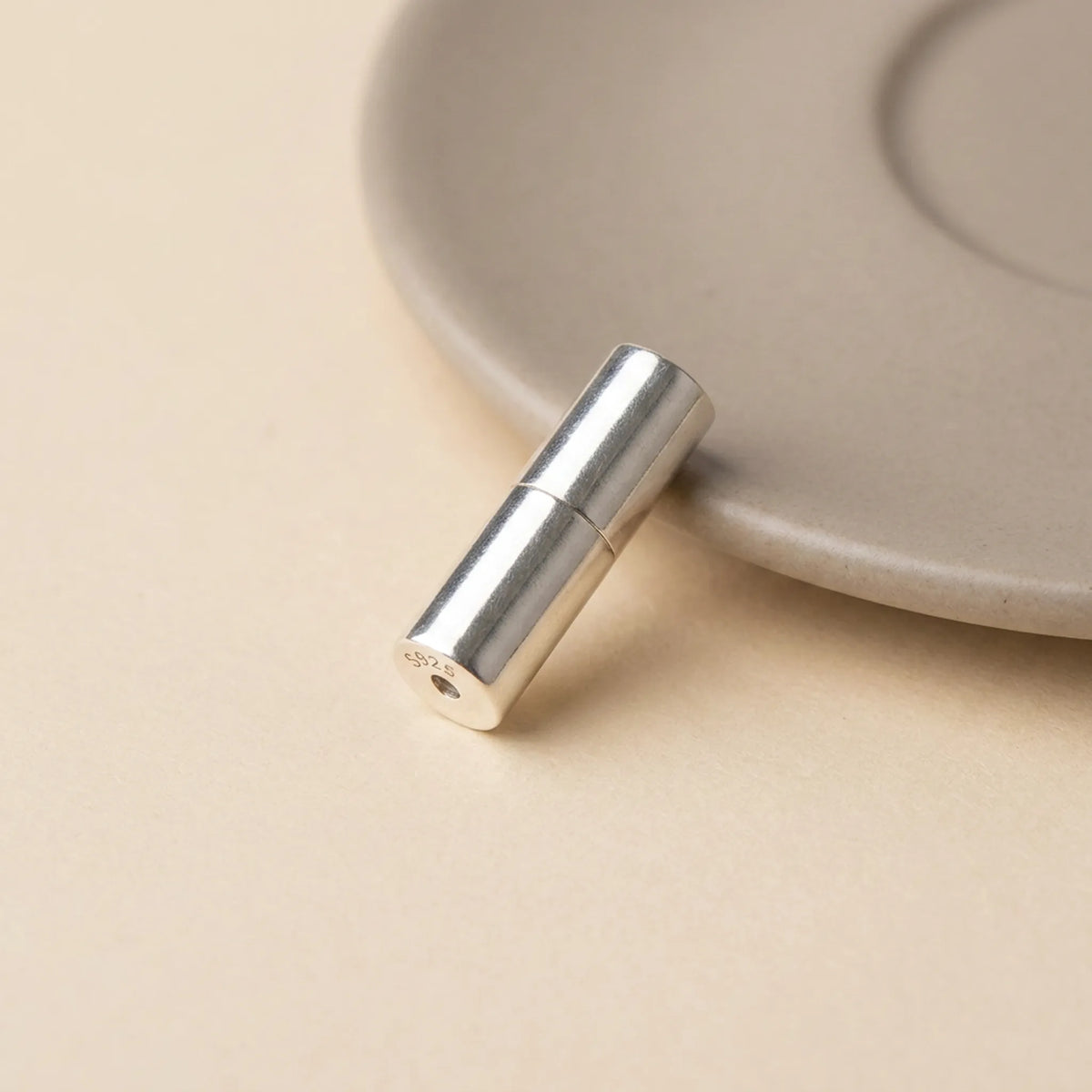 Sterling silver barrel screw clasp closed in smooth cylindrical shape