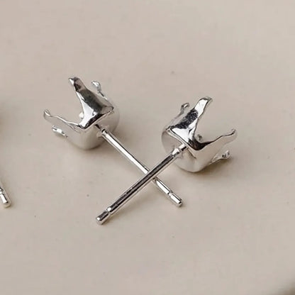 Close-up of 925 sterling silver 4-prong stud earring settings for round stones and crystals