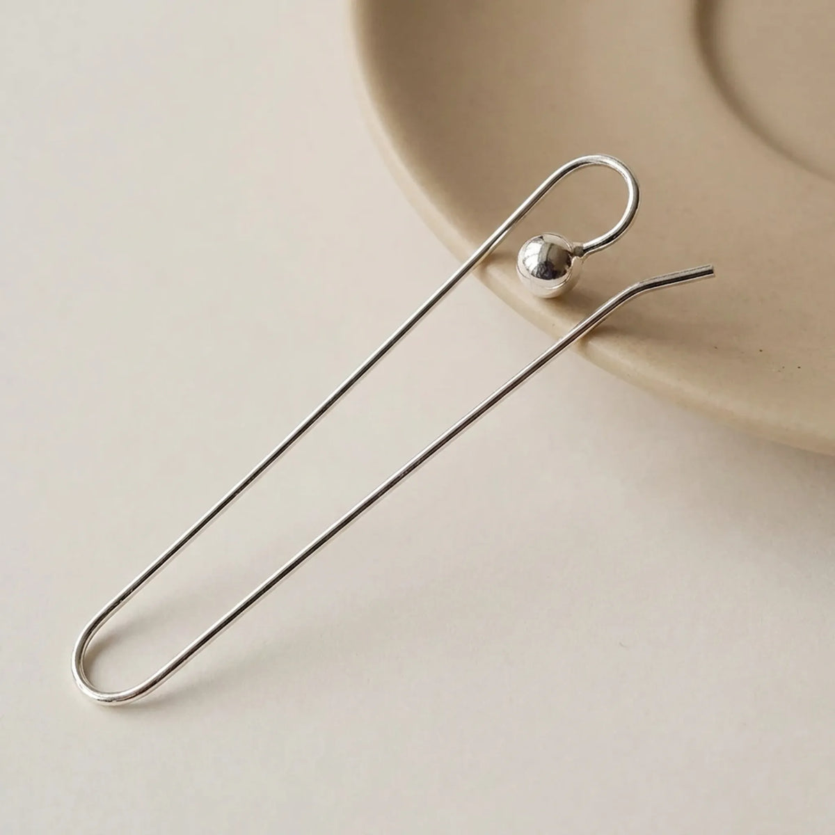 Close-up of 925 sterling silver large earring hook findings with polished stopper bead