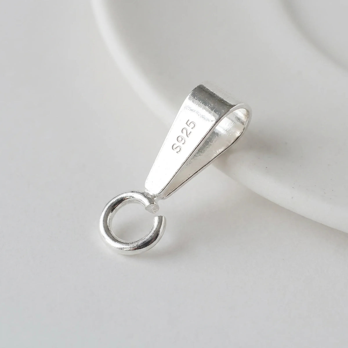Close-up of 925 sterling silver pendant bail with open jump ring and S925 hallmark