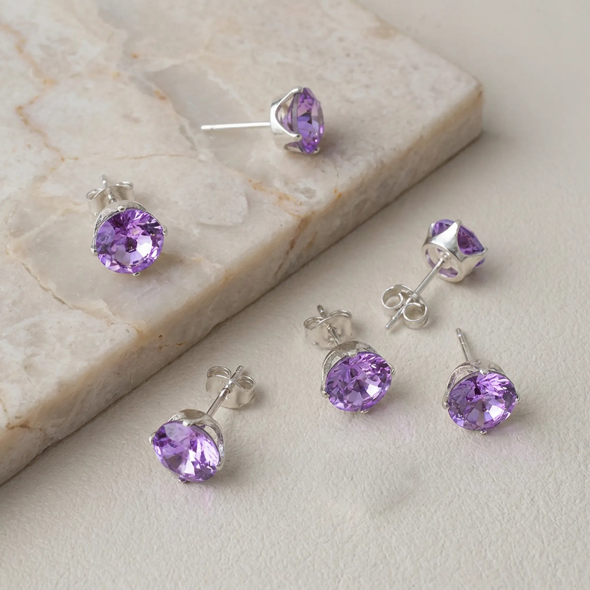 925 sterling silver Snaptite stud earring settings with round purple stones in 4-prong settings