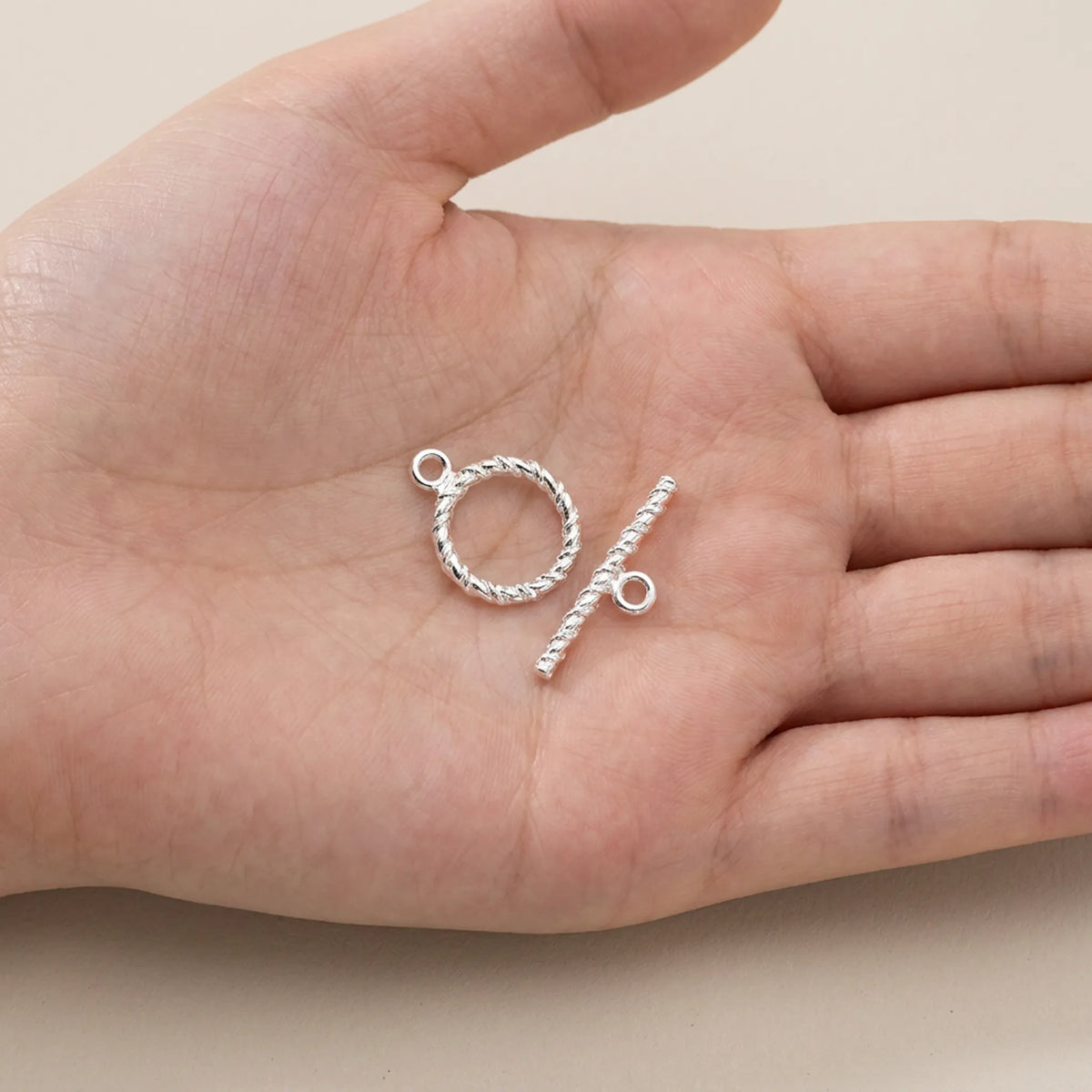 925 sterling silver twisted toggle clasp shown in hand for size reference