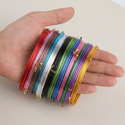 Anodized aluminum craft wire shown in hand for size comparison