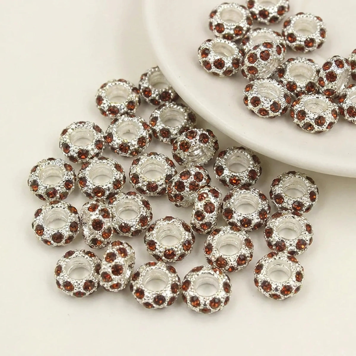Brown rhinestone spacer beads with large holes and silver tone finish