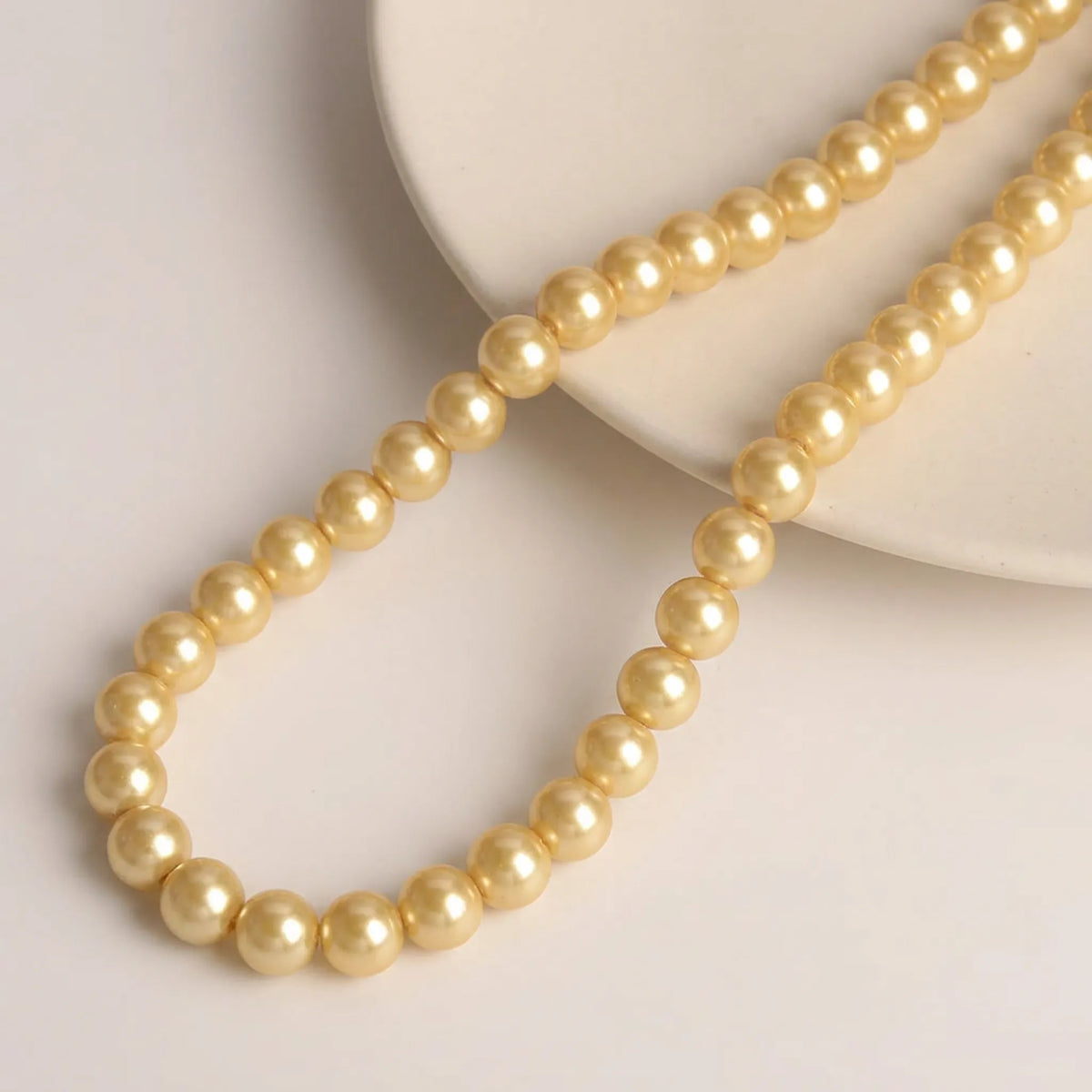 Champagne glass pearl beads arranged on a 16 inch strand