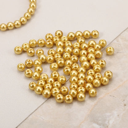 Close-up of champagne glass pearl beads with smooth pearl finish