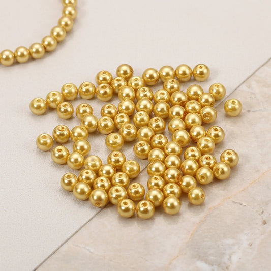 Close-up of champagne glass pearl beads with smooth pearl finish