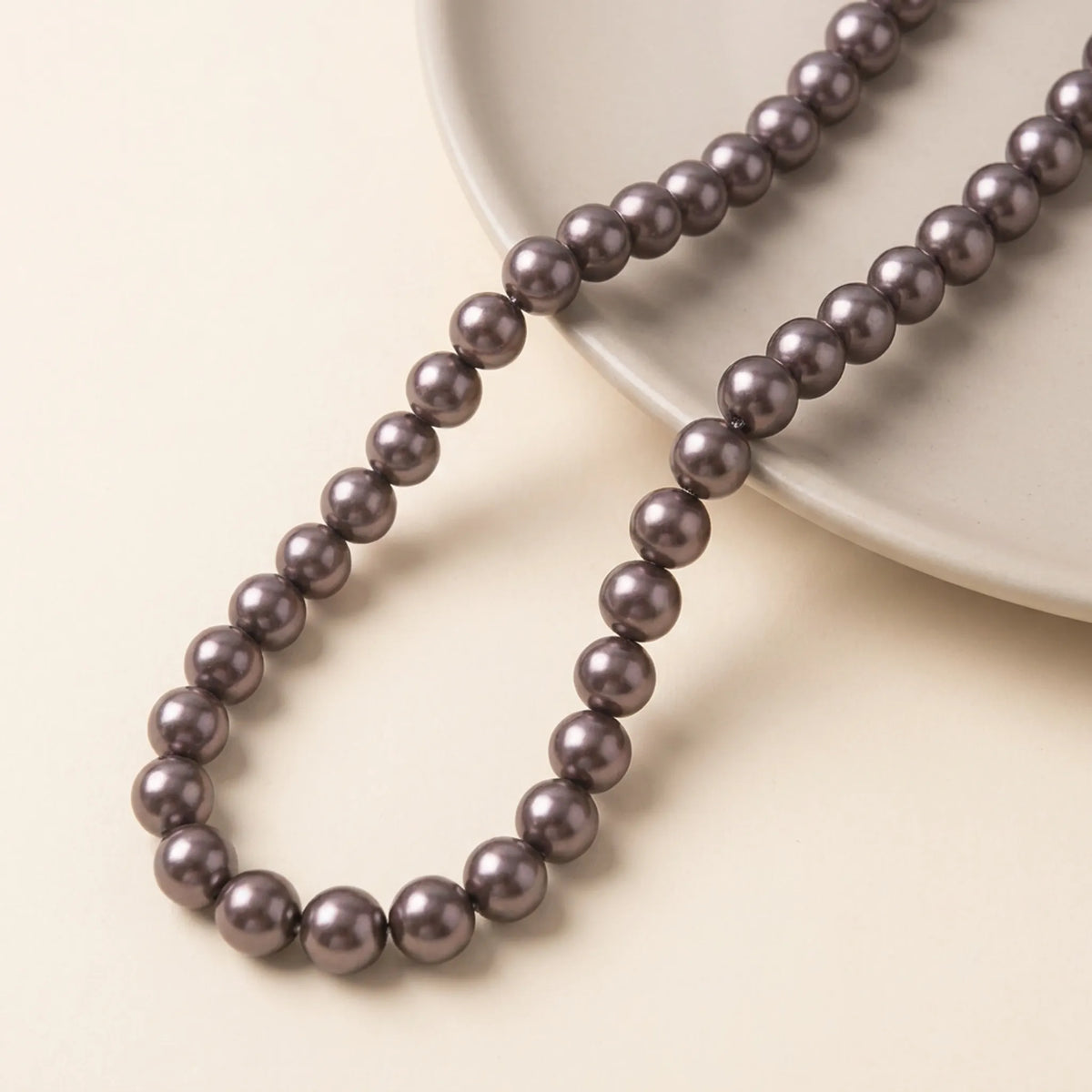 Chocolate glass pearl beads arranged on a 16 inch strand