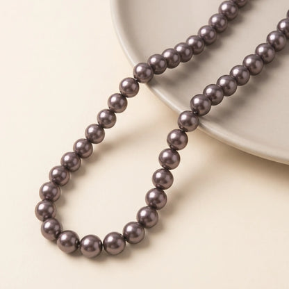 Chocolate glass pearl beads arranged on a 16 inch strand