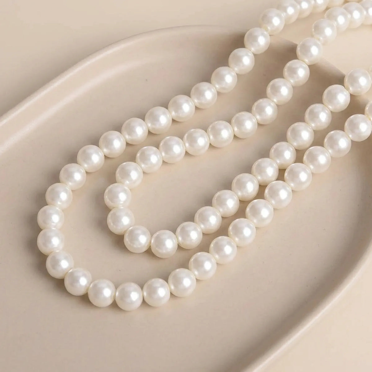 Smooth cream glass pearl round beads with pearl coated finish