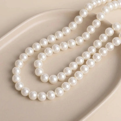 Smooth cream glass pearl round beads with pearl coated finish