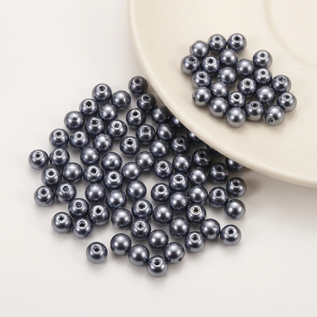 Close-up of Dark Gray Glass Pearl Beads with smooth pearl coated finish and round shape