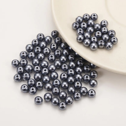 Close-up of Dark Gray Glass Pearl Beads with smooth pearl coated finish and round shape
