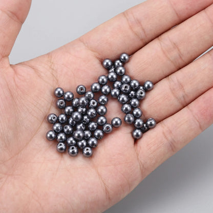 Dark Gray Glass Pearl Beads shown in hand for size comparison, pearl coated round glass beads for jewelry making