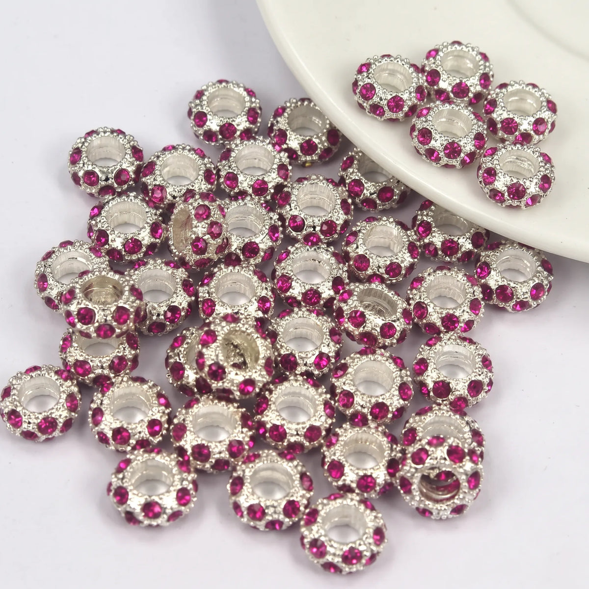 Fuchsia rhinestone spacer beads with large holes and silver tone finish