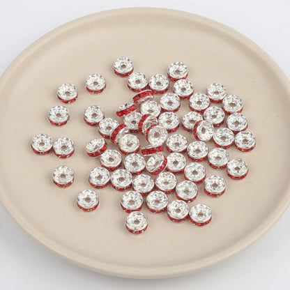 Light Siam crystal rhinestone spacer beads on display for jewelry making and beadwork