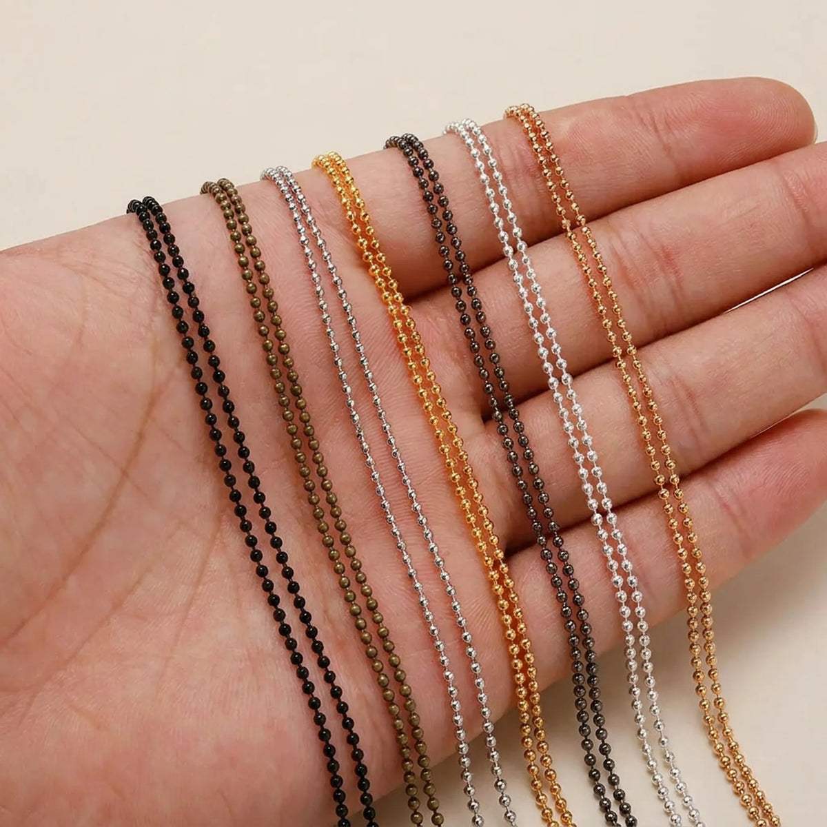 Metal ball chain shown in hand for size comparison