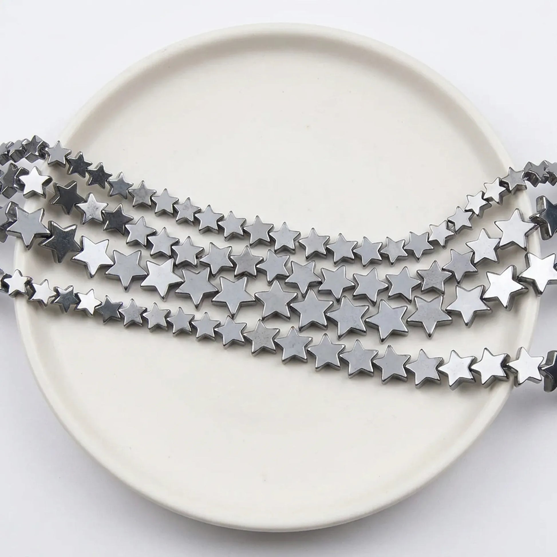 Metallic silver star hematite beads close up