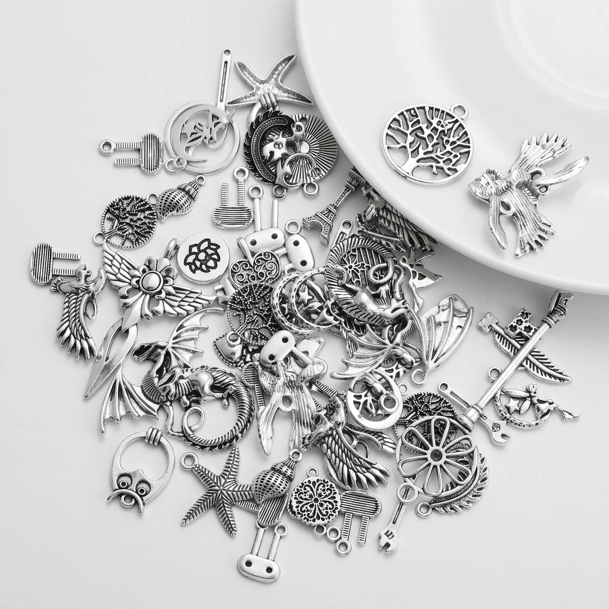 Mixed silver tone large charms with dragons birds stars trees and assorted designs