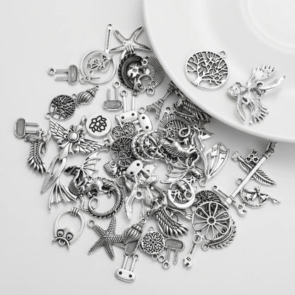 Mixed silver tone large charms with dragons birds stars trees and assorted designs