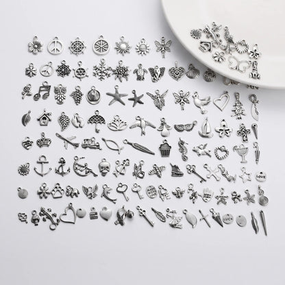 Assorted silver tone charms in mixed designs for bracelets necklaces and crafts