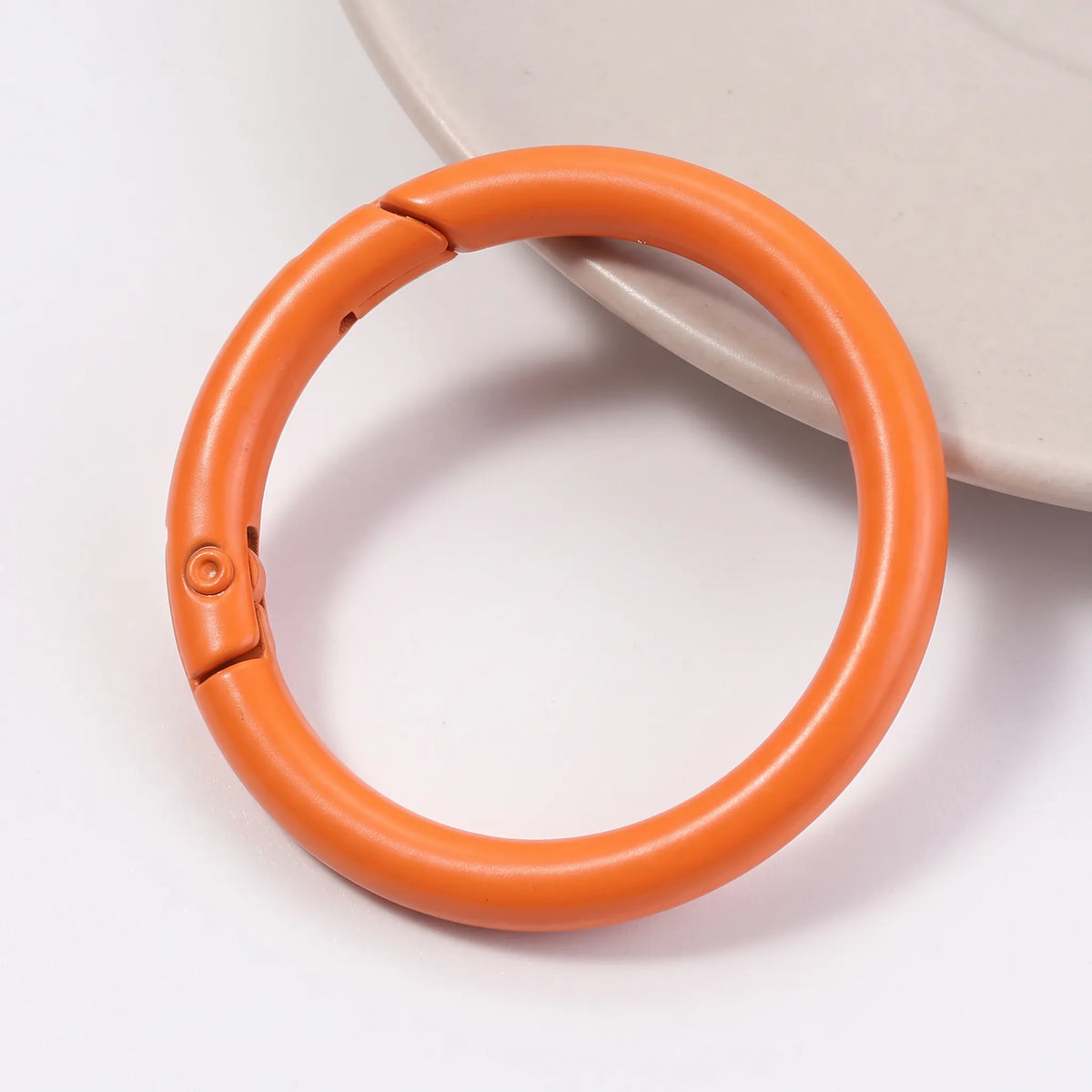 Orange metal round carabiner clasp with openable spring closure
