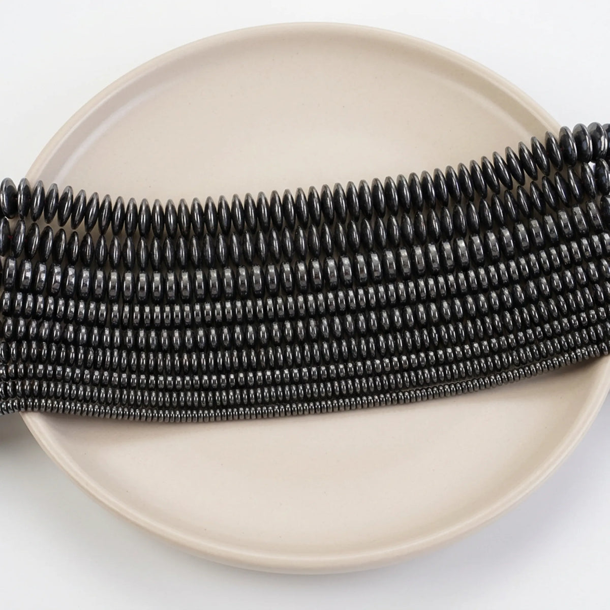 Natural hematite flat rondelle beads in assorted sizes with smooth black metallic finish