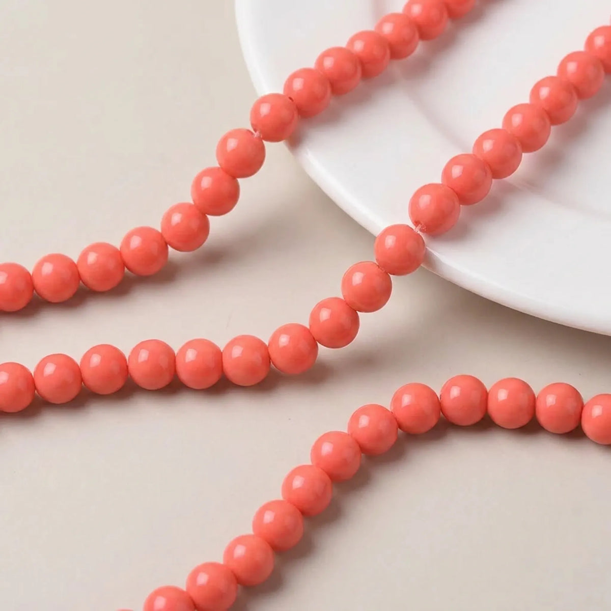 Close up of orange coated opaque glass round beads