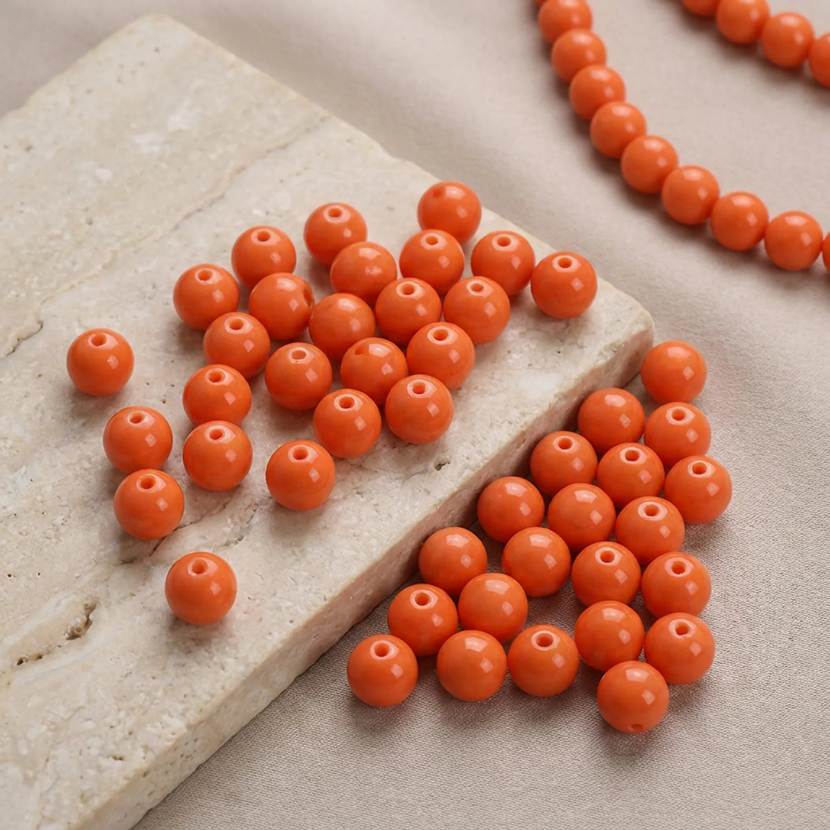 Orange coated opaque glass round beads used in a handmade bracelet