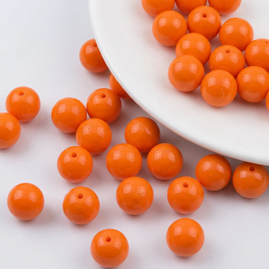 Loose orange coated opaque glass round beads