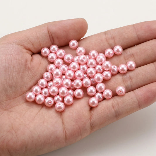 Pink Czech Glass Pearl Beads shown in hand for size comparison, pearl coated round glass beads for jewelry making