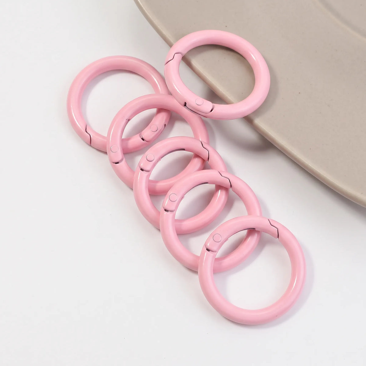 Light pink metal round carabiner clasps for DIY craft projects