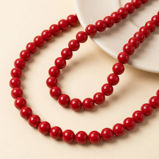 Red coated glass round beads on a 16 inch strand for jewelry making