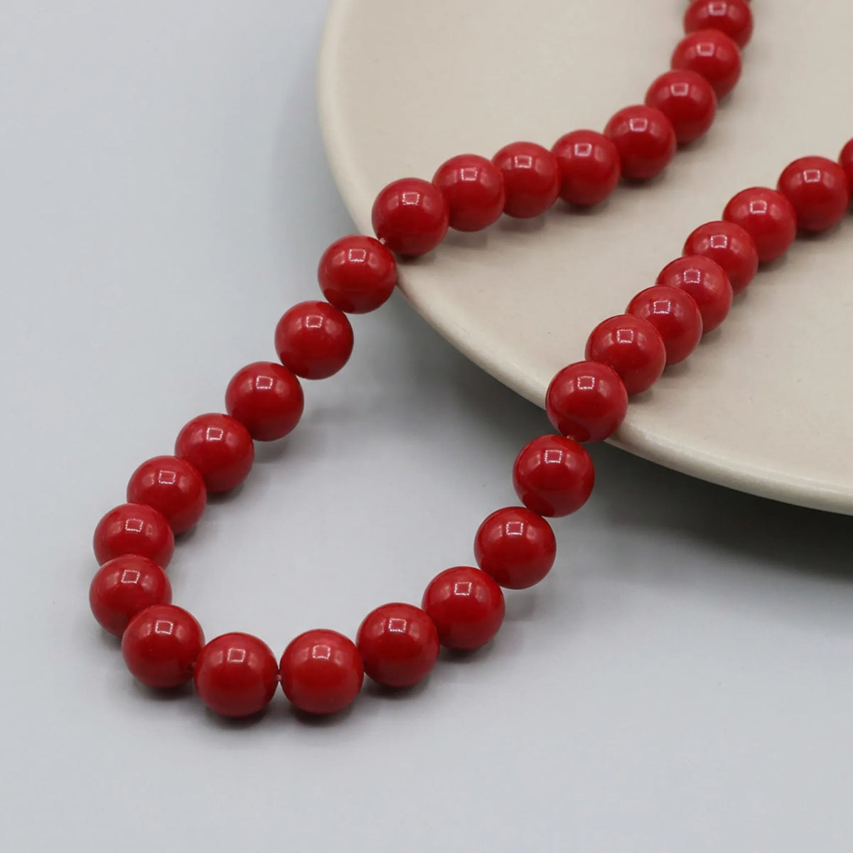 Glossy red coated glass round bead strand for jewelry making