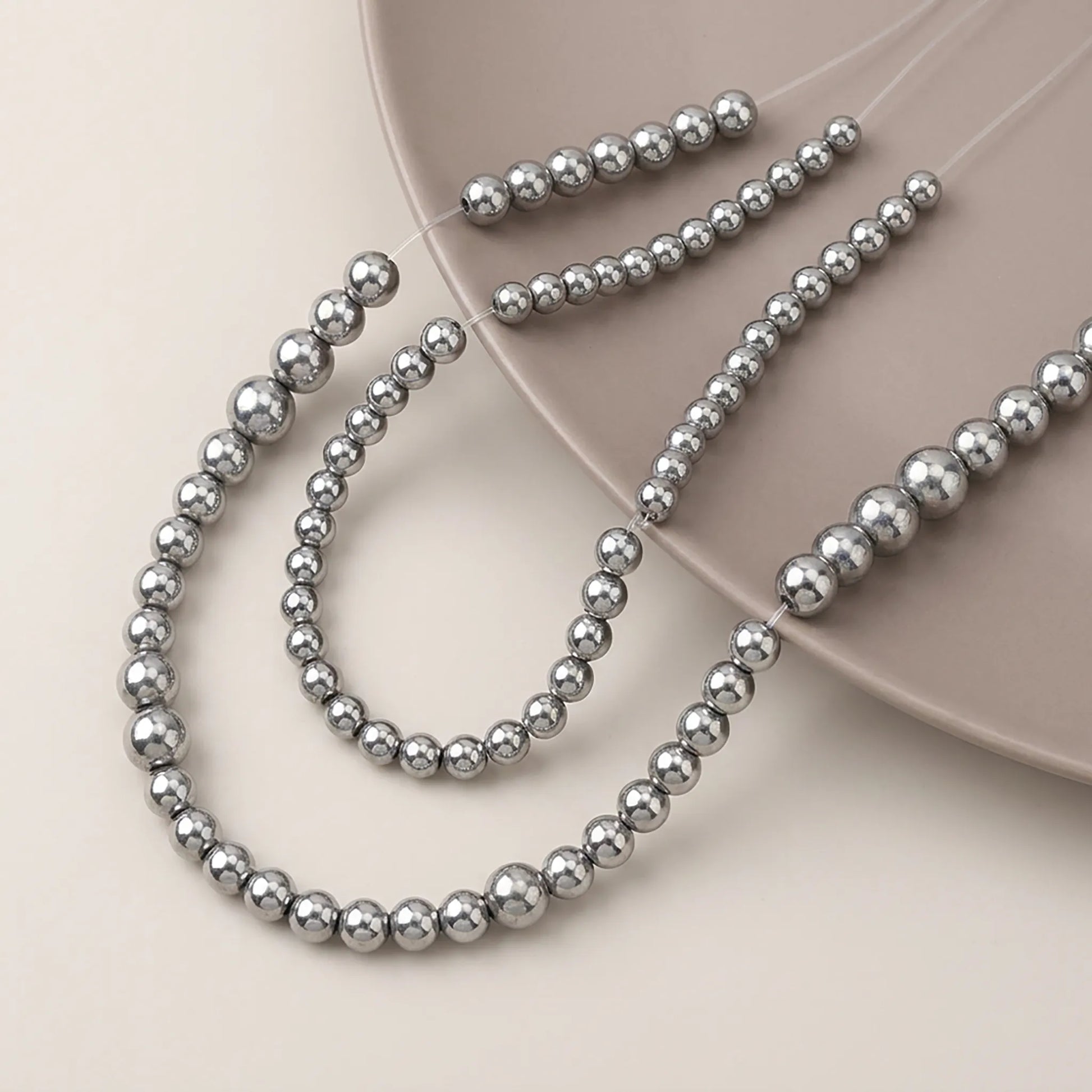 Round silver hematite beads with smooth metallic surface