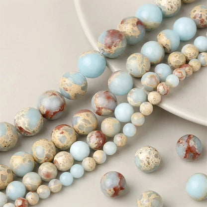 Close-up of smooth natural Shoushan Jasper round beads in 4–12mm sizes