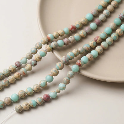 Matte Shoushan stone bead strands with blue, cream and muted pink natural patterns