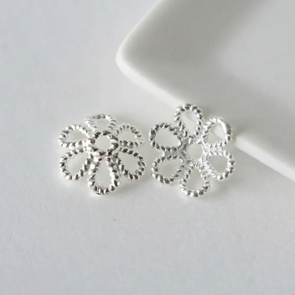 Pair of sterling silver twisted flower bead caps with openwork petals