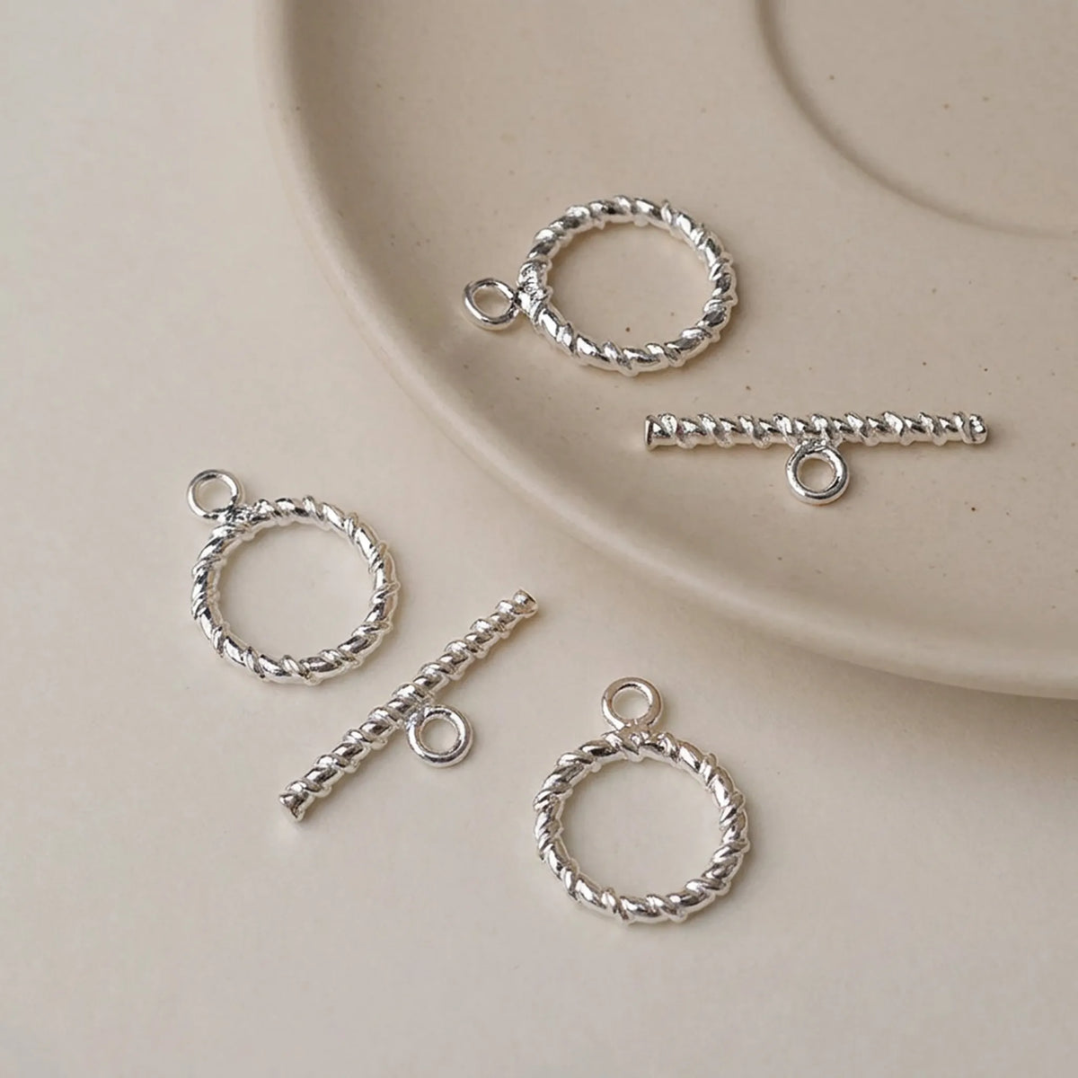 Sterling silver twisted toggle clasps with round rings and textured bars