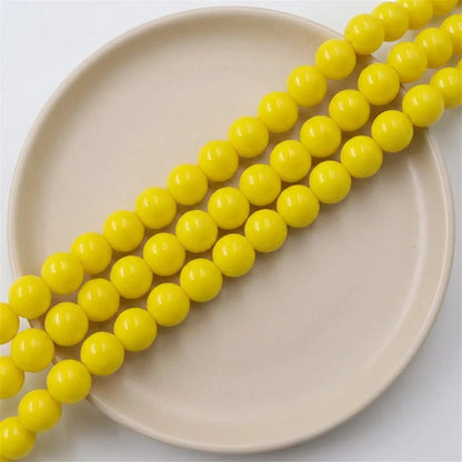 Loose yellow coated opaque glass round beads