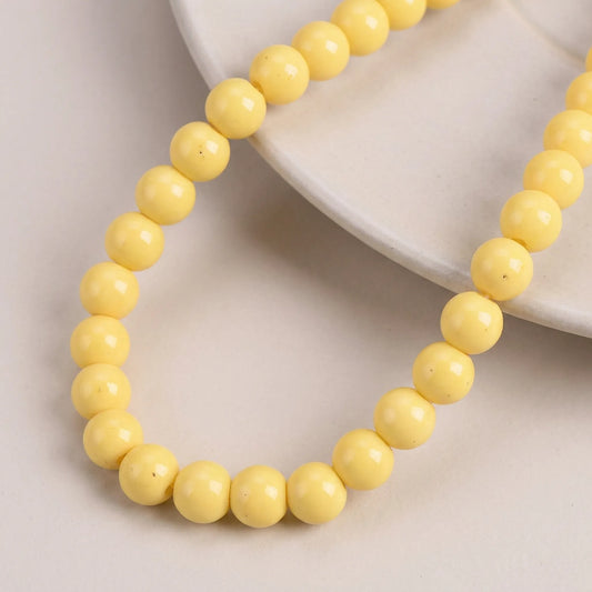 Yellow coated opaque glass round beads for jewelry making